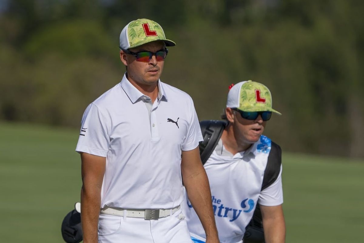 January 4, 2024; Maui, Hawaii, USA; Rickie Fowler (left) and caddie caddie Ricky Romano (right) walk on the fourth hole during the first round of The Sentry Tournament of Champions golf tournament at Kapalua Golf - The Plantation Course.