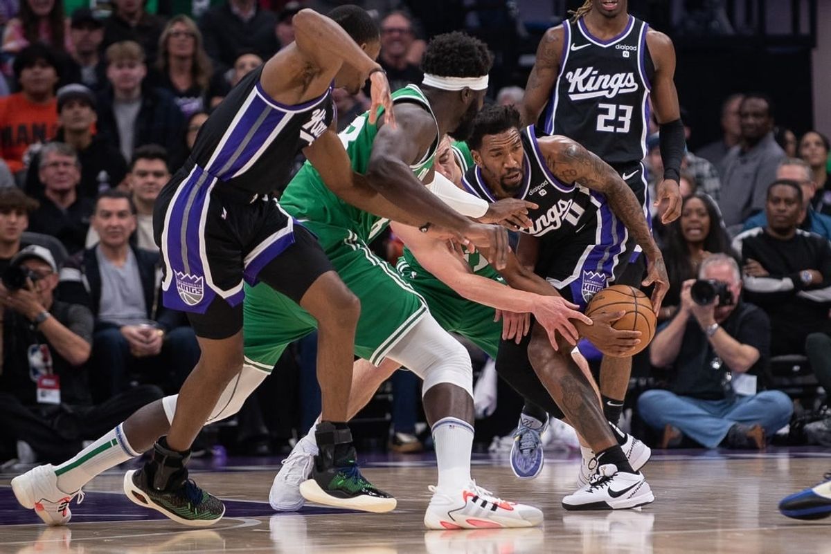 Dec 20, 2023; Sacramento, California, USA; Sacramento Kings guard Malik Monk (0) and Boston Celtics guard Payton Pritchard (11) fight for possession of the ball during the first quarter at Golden 1 Center.