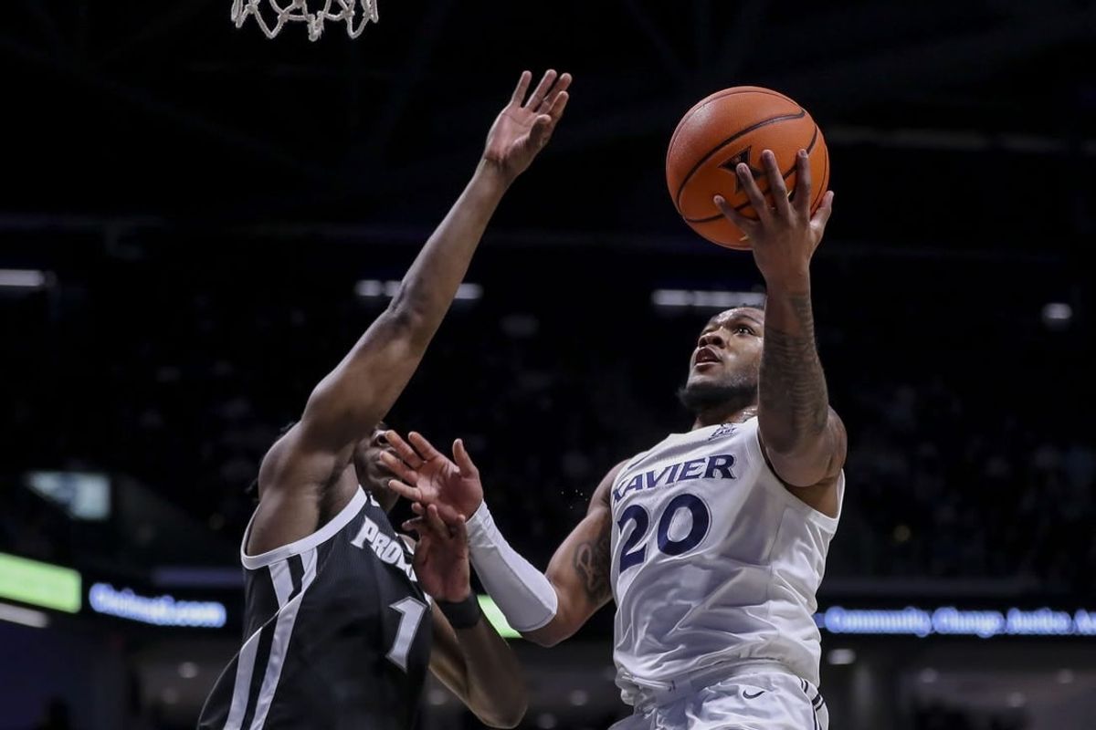 Feb 21, 2024; Cincinnati, Ohio, USA; Xavier Musketeers guard Dayvion McKnight (20) shoots against Providence Friars guard Jayden Pierre (1) in the first half at Cintas Center.