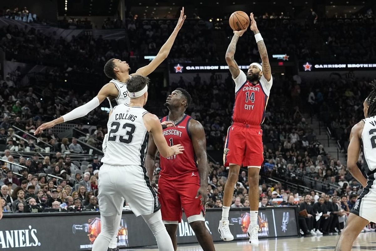 Dec 17, 2023; San Antonio, Texas, USA; New Orleans Pelicans Brandon Ingram (14) shoots over San Antonio Spurs forward Victor Wembanyama (1) during the first half at Frost Bank Center.