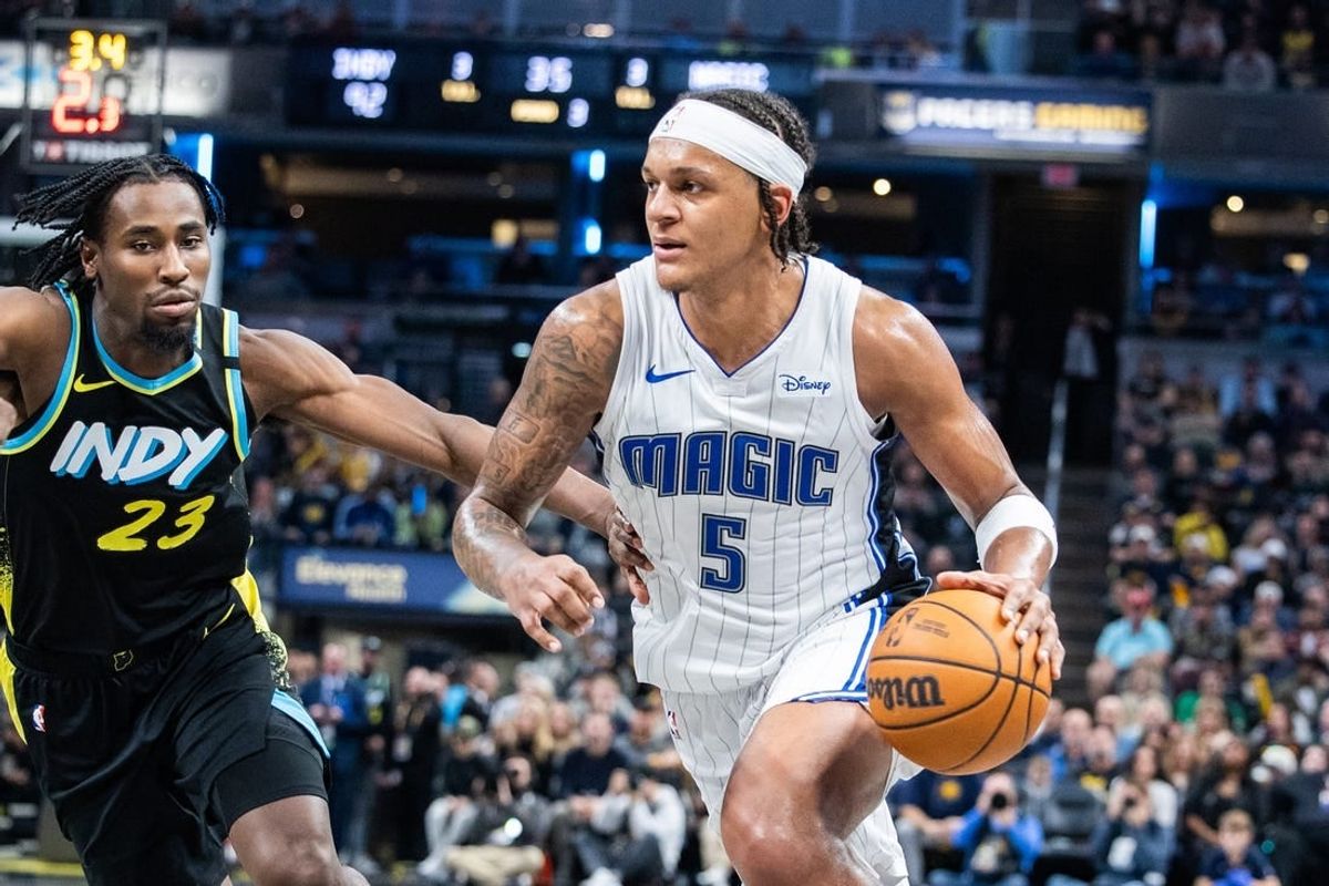 Dec 23, 2023; Indianapolis, Indiana, USA; Orlando Magic forward Paolo Banchero (5) dribbles the ball while Indiana Pacers forward Aaron Nesmith (23) defends in the second half at Gainbridge Fieldhouse.