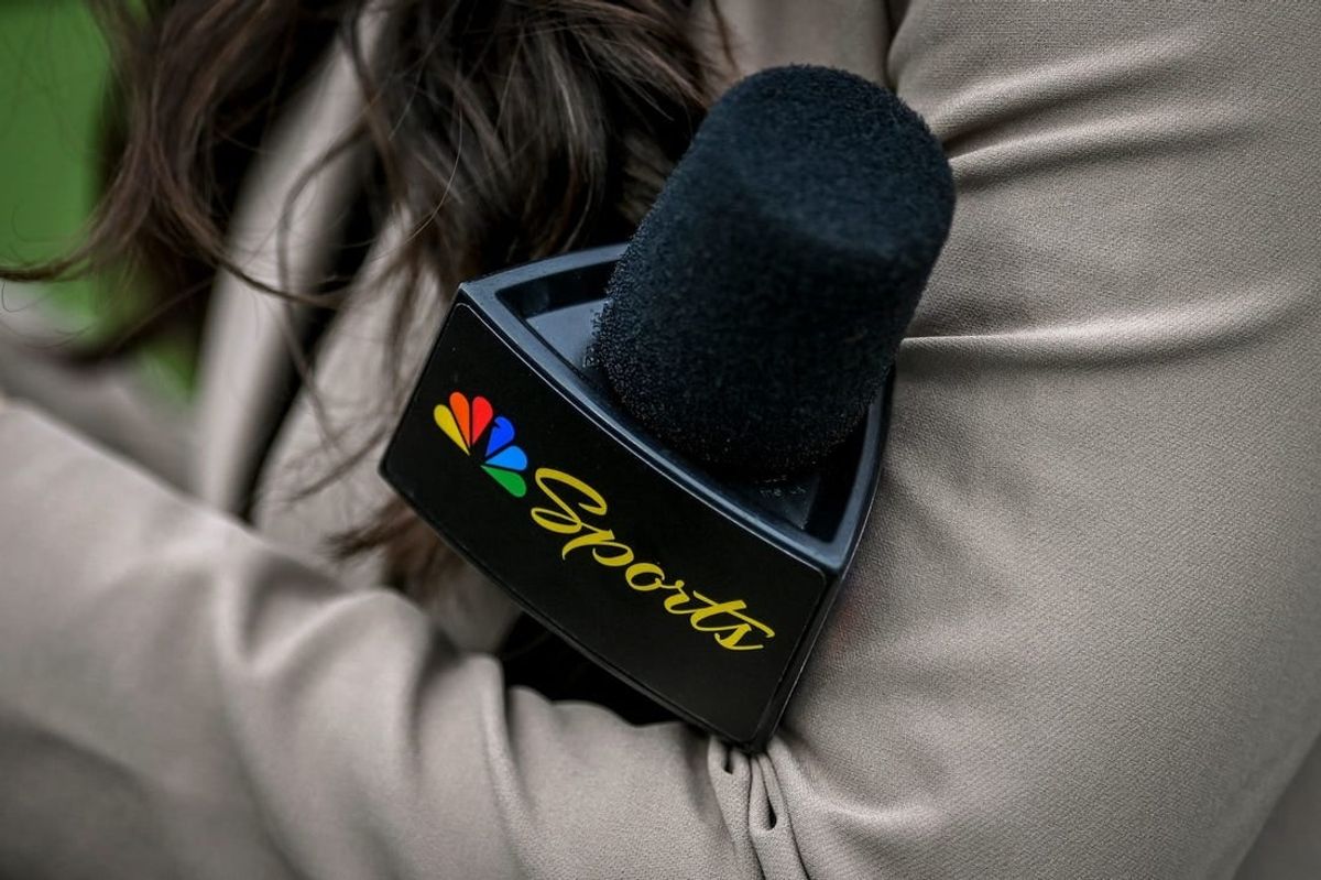 A Peacock sideline reporter holds a microphone with the NBC Peacock logo during Michigan State's football game against Washington on Saturday, Sept. 16, 2023, at Spartan Stadium in East Lansing.