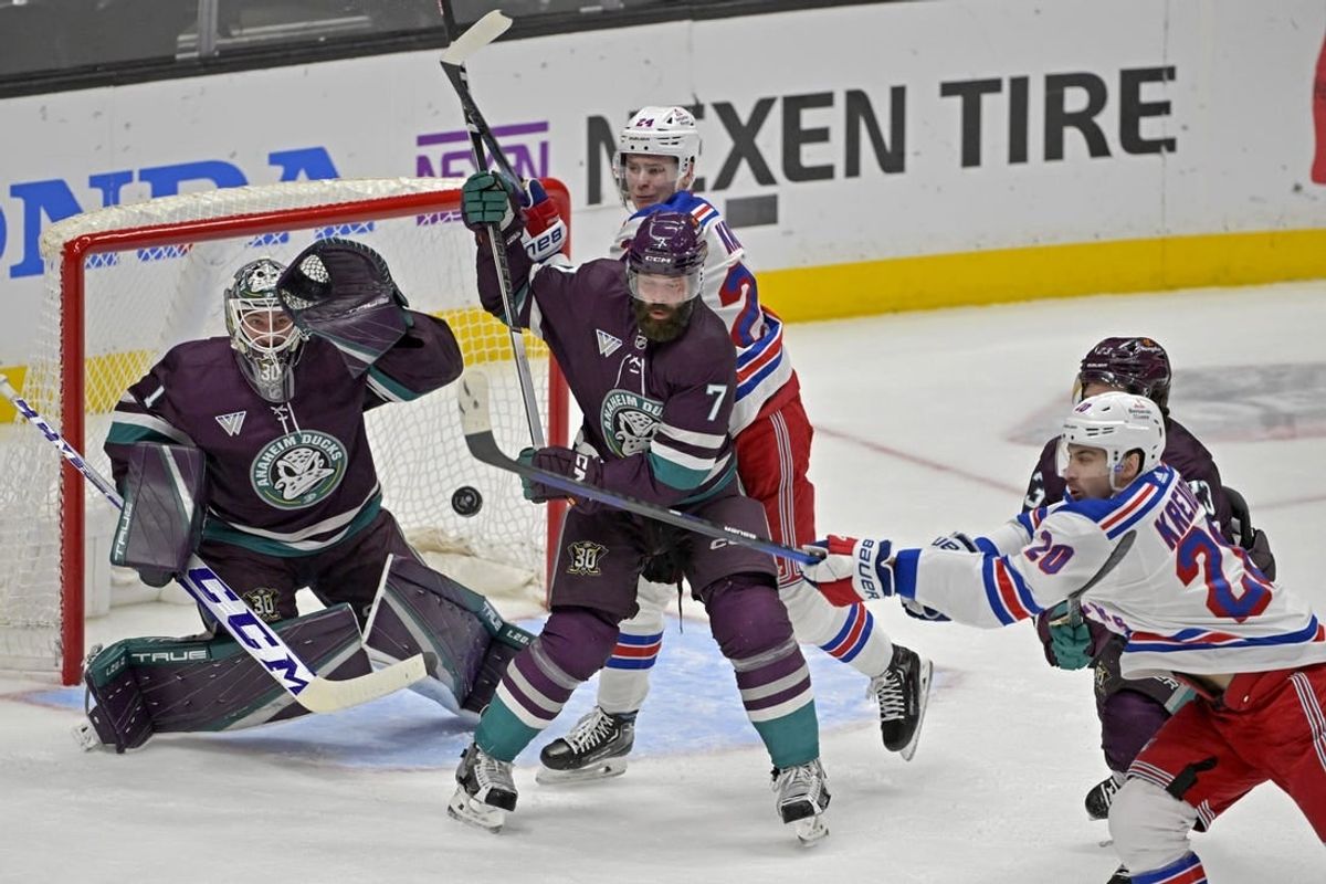 Jan 21, 2024; Anaheim, California, USA; Anaheim Ducks goaltender Lukas Dostal (1) looks to make a glove save off a shot by New York Rangers left wing Chris Kreider (20) as Anaheim Ducks defenseman Radko Gudas (7) and New York Rangers right wing Kaapo Kakko (24) battle in front of the net in the first period at Honda Center.