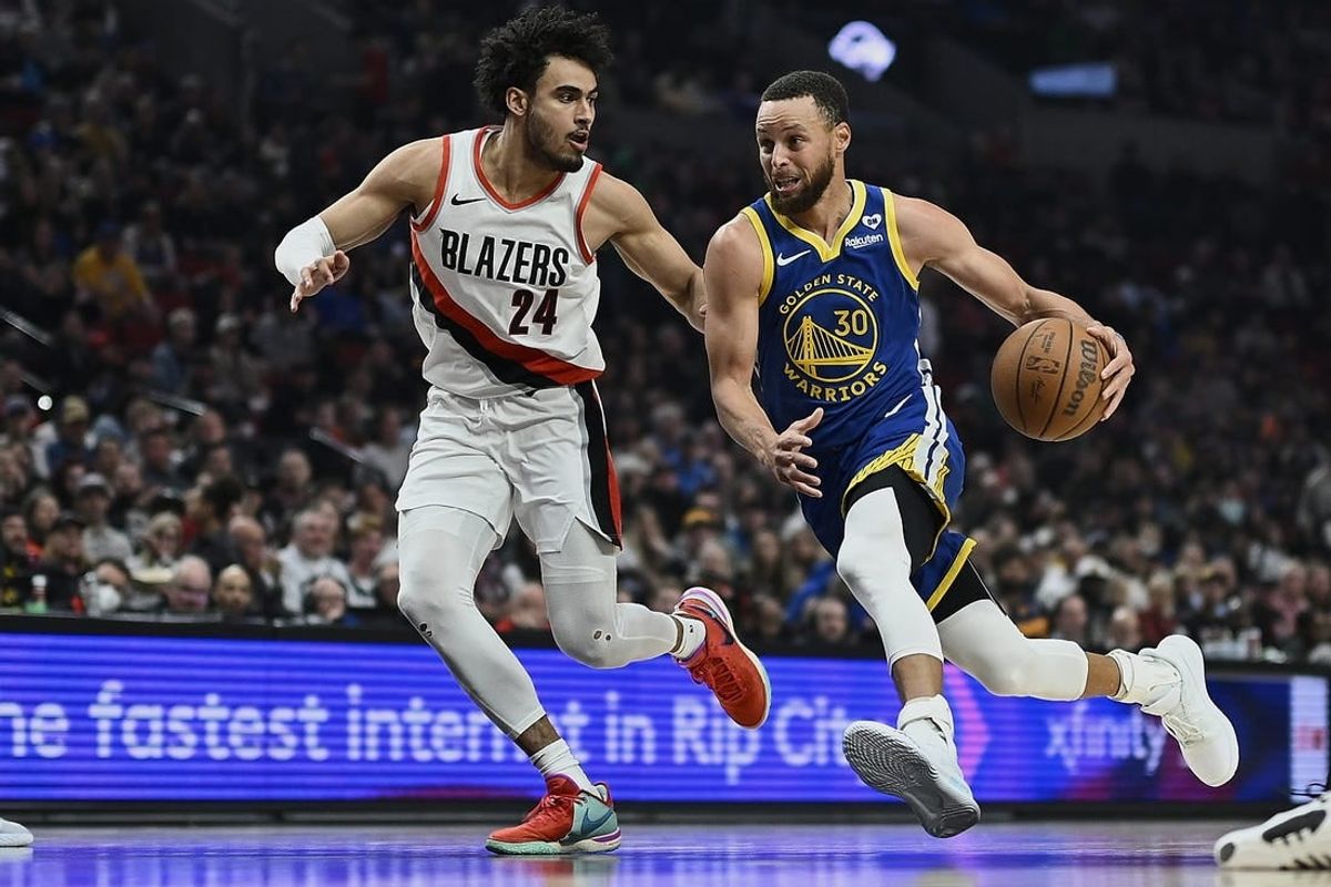 Apr 11, 2024; Portland, Oregon, USA; Golden State Warriors guard Stephen Curry (30) drives to the basket during the first half against Portland Trail Blazers forward Justin Minaya (24) at Moda Center.