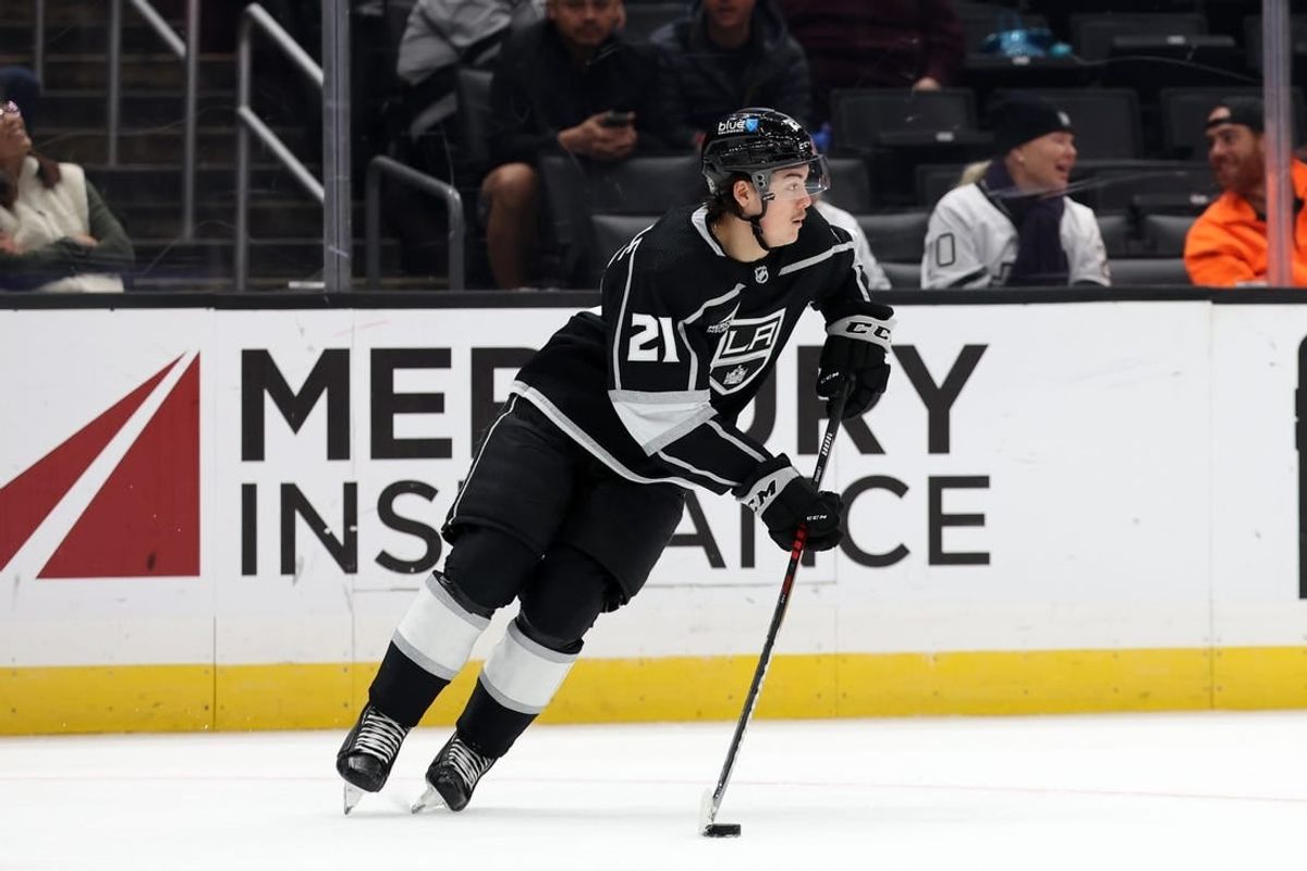 Nov 11, 2023; Los Angeles, California, USA;  Los Angeles Kings defenseman Jordan Spence (21) controls the puck during the third period against the Philadelphia Flyers at Crypto.com Arena.
