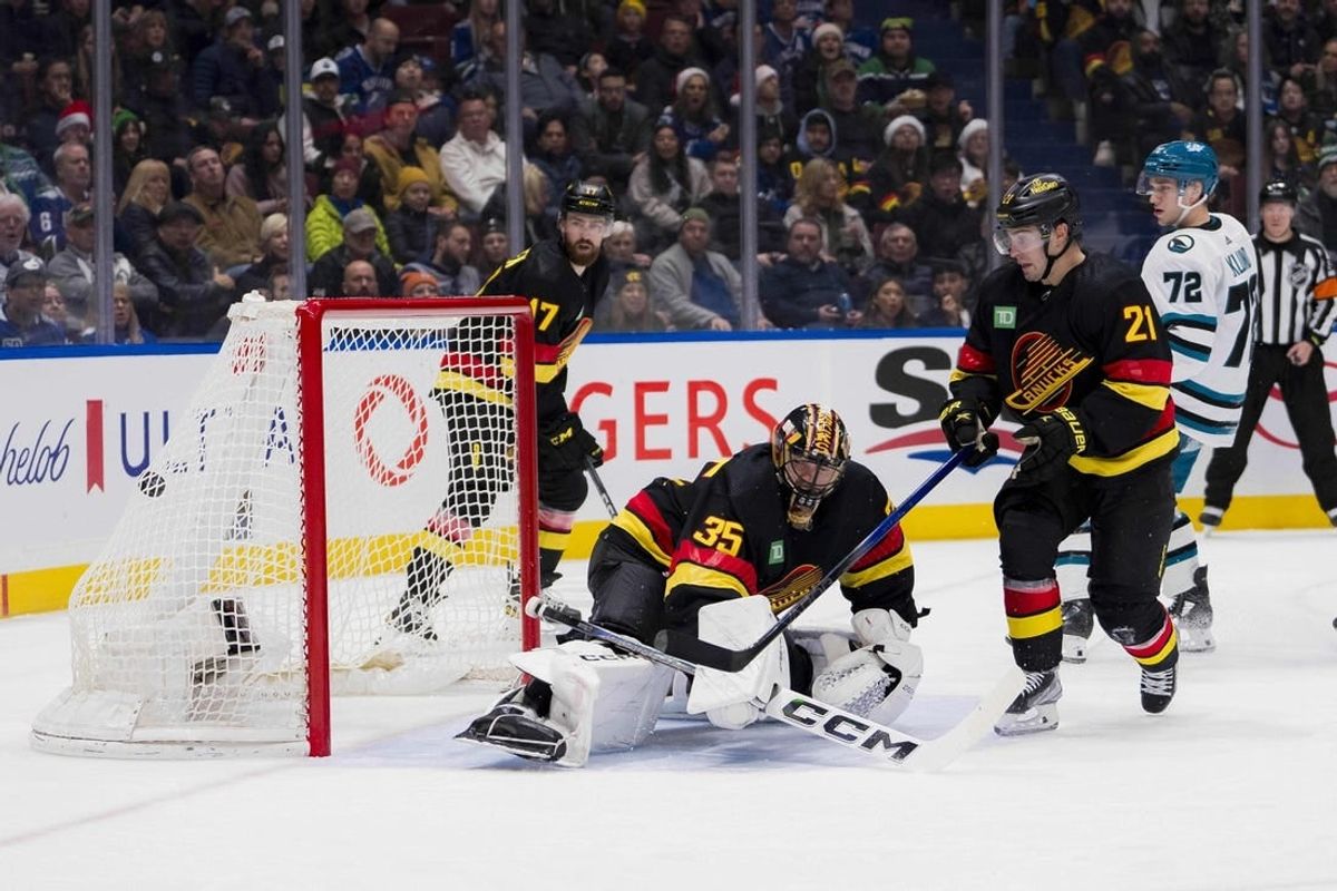 Dec 23, 2023; Vancouver, British Columbia, CAN; San Jose Sharks forward William Eklund (72) and Vancouver Canucks forward Nils Hoglander (21) watch the shot from forward Fabian Zetterlund (20) beat goalie Thatcher Demko (35) in the second period at Rogers Arena.
