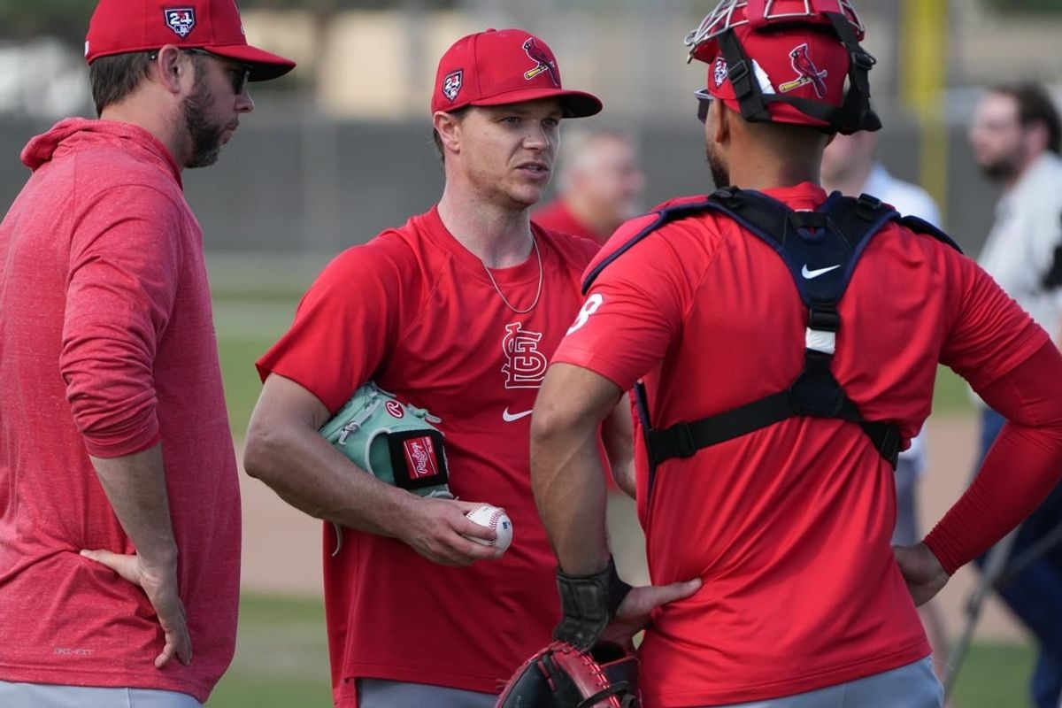Feb 15, 2024; Jupiter, FL, USA;  St. Louis Cardinals starting pitcher Sonny Gray, center, talks with catcher Ivan Herrera (48) during workouts at spring training.
