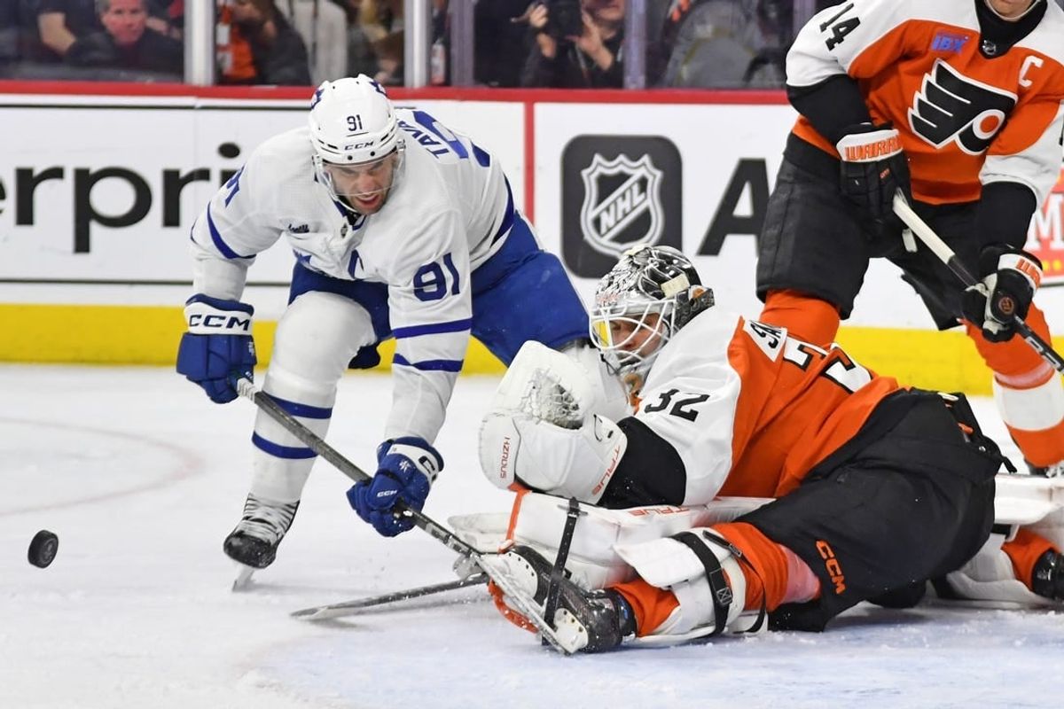 Mar 14, 2024; Philadelphia, Pennsylvania, USA; Philadelphia Flyers goaltender Felix Sandstrom (32) makes a save against Toronto Maple Leafs center John Tavares (91) during the second period at Wells Fargo Center.