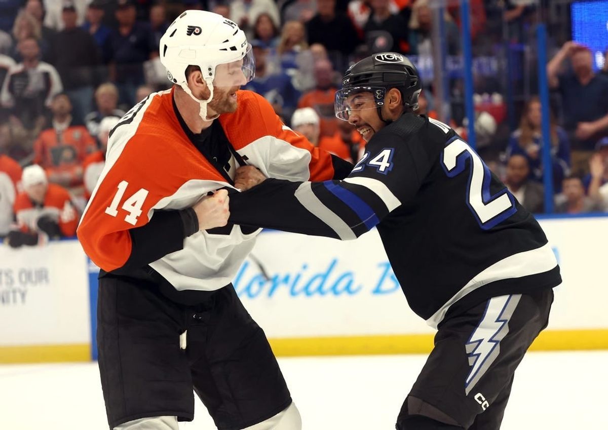 Mar 9, 2024; Tampa, Florida, USA;Philadelphia Flyers center Sean Couturier (14) and Tampa Bay Lightning defenseman Matt Dumba (24) fight during the second period at Amalie Arena.