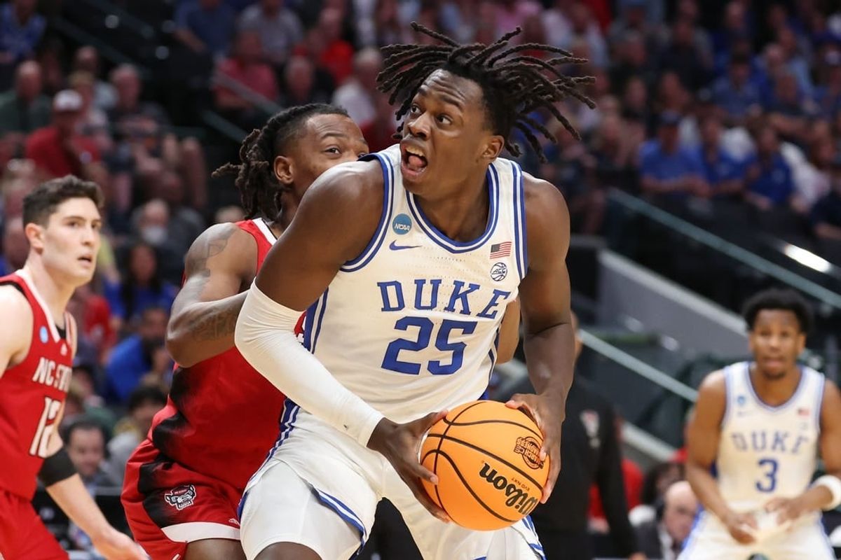 Mar 31, 2024; Dallas, TX, USA; Duke Blue Devils forward Mark Mitchell (25) controls the ball against North Carolina State Wolfpack guard DJ Horne (0) in the first half in the finals of the South Regional of the 2024 NCAA Tournament at American Airline Center.