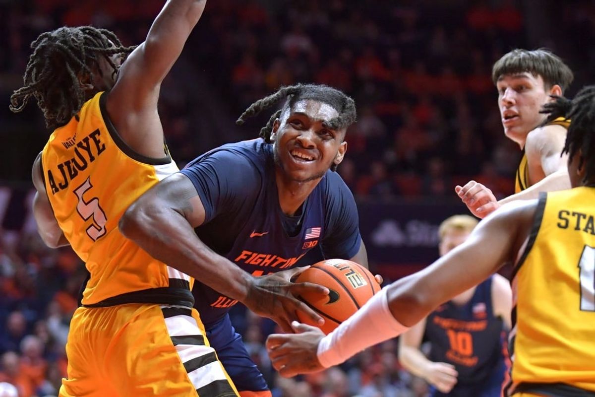 Nov 17, 2023; Champaign, Illinois, USA; Illinois Fighting Illini forward Dain Dainja (42) moves around Valparaiso Beacons forward Ola Ajiboye (5) as he drives to the basket during the first half at State Farm Center.