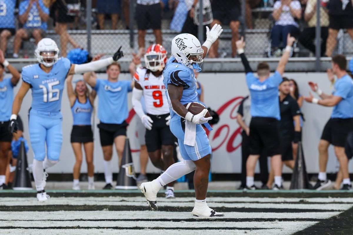 Nov 11, 2023; Orlando, Florida, USA; UCF Knights running back RJ Harvey (7) celebrates after scoring a touchdown during the first quarter against the Oklahoma State Cowboys at FBC Mortgage Stadium.