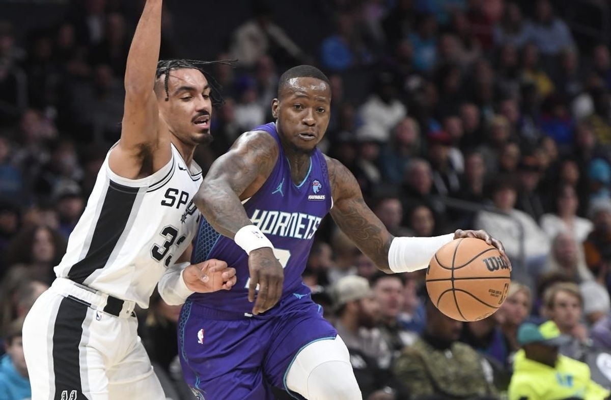 Jan 19, 2024; Charlotte, North Carolina, USA;  Charlotte Hornets guard Terry Rozier (3) moves in past the defense of San Antonio Spurs guard Tre Jones (33) during the first half at the Spectrum Center.