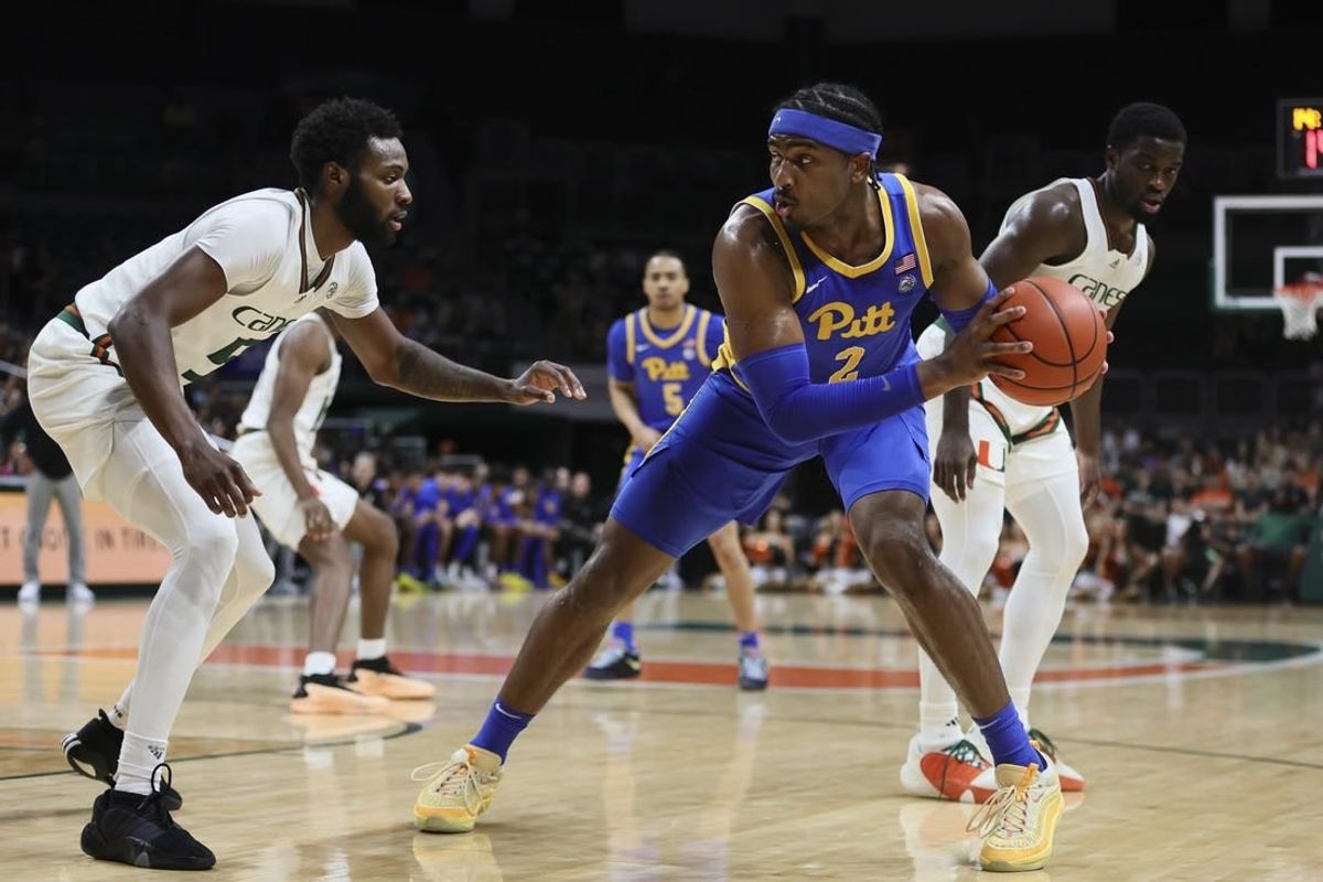 Jan 27, 2024; Coral Gables, Florida, USA; Pittsburgh Panthers forward Blake Hinson (2) protects the basketball from Miami Hurricanes guard Wooga Poplar (5) during the first half at Watsco Center.