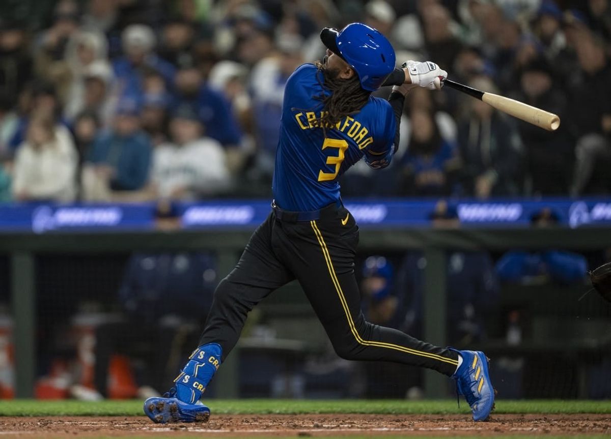 Mar 29, 2024; Seattle, Washington, USA; Seattle Mariners shortstop J.P. Crawford (3) hits a solo home run during the sixth inning against the Boston Red Sox at T-Mobile Park.