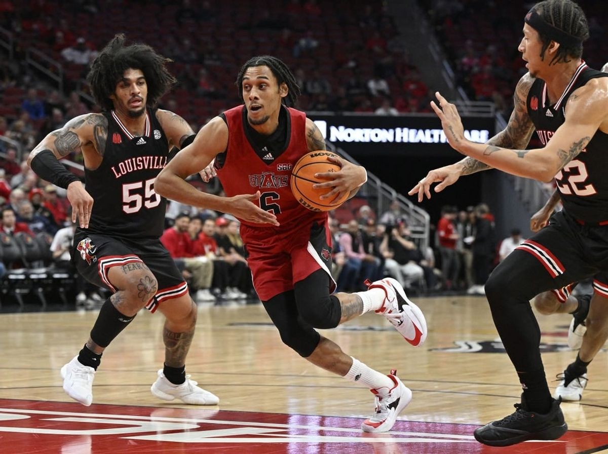 Dec 13, 2023; Louisville, Kentucky, USA; Arkansas State Red Wolves guard Taryn Todd (6) drives to the basket against Louisville Cardinals guard Skyy Clark (55) and  guard Tre White (22) during the first half at KFC Yum! Center.