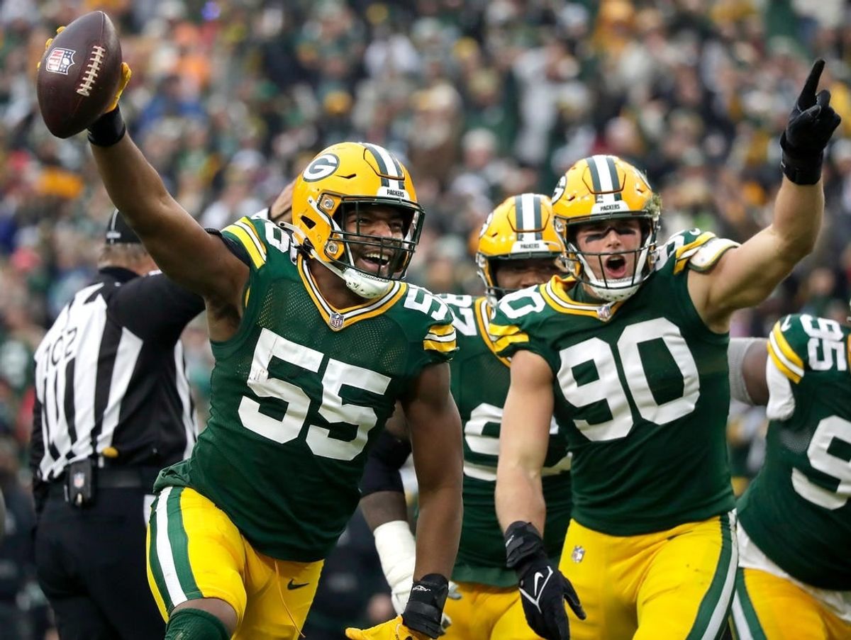 Green Bay Packers linebacker Kingsley Enagbare (55) and linebacker Lukas Van Ness (90) celebrate following Enagbare's fumble recovery against the Tampa Bay Buccaneers during their football game on Sunday, December 17, 2023, at Lambeau Field in Green Bay Wis.