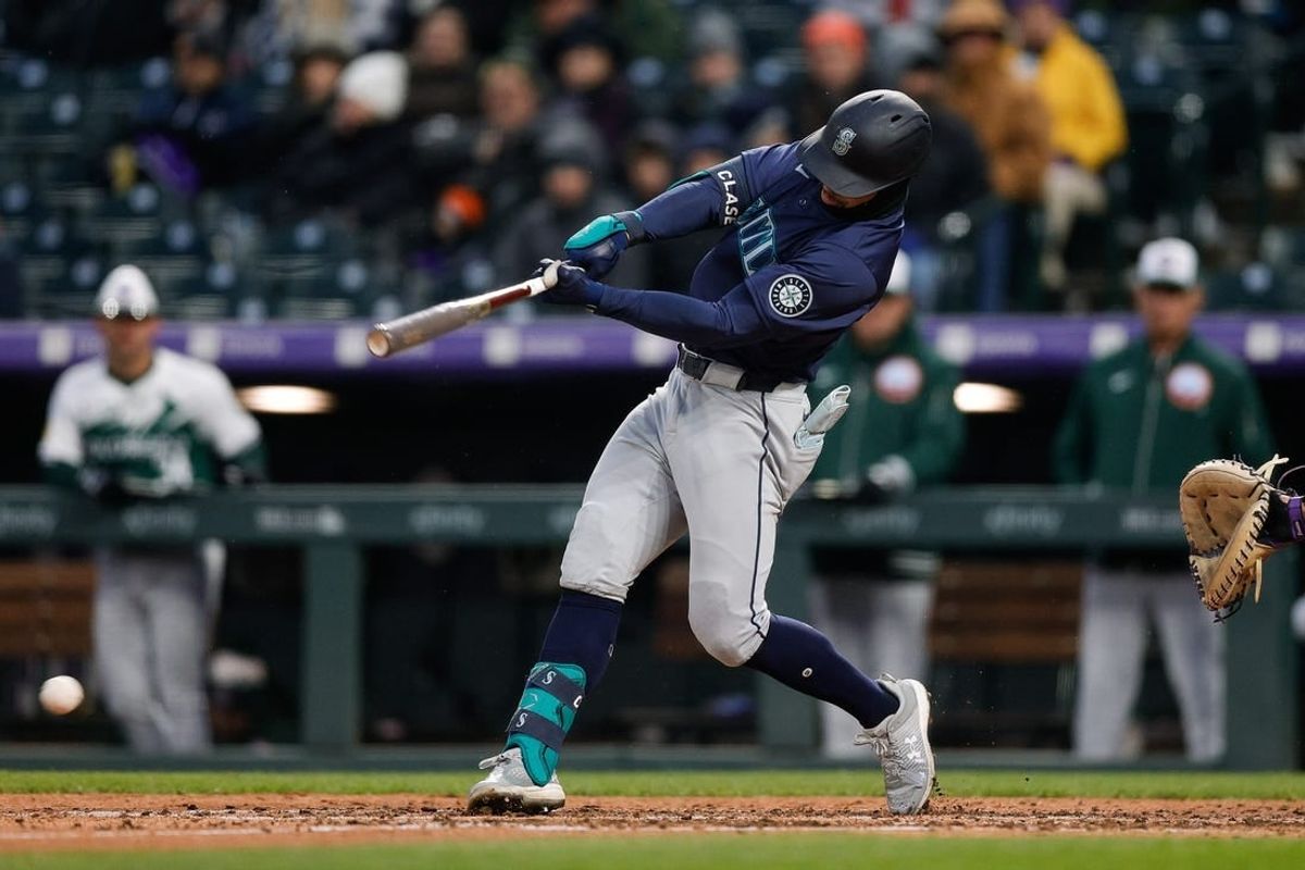 Apr 20, 2024; Denver, Colorado, USA; Seattle Mariners left fielder Jonatan Clase (5) hits a 3 RBI single on a Colorado Rockies error in the fifth inning at Coors Field.