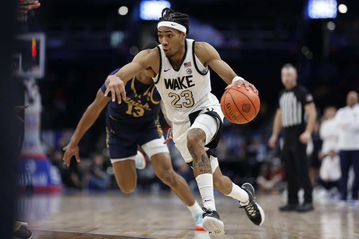 Mar 13, 2024; Washington, D.C., USA; Wake Forest Demon Deacons guard Hunter Sallis (23) drives to the basket past Notre Dame Fighting Irish forward Tae Davis (13) in the second half at Capital One Arena.