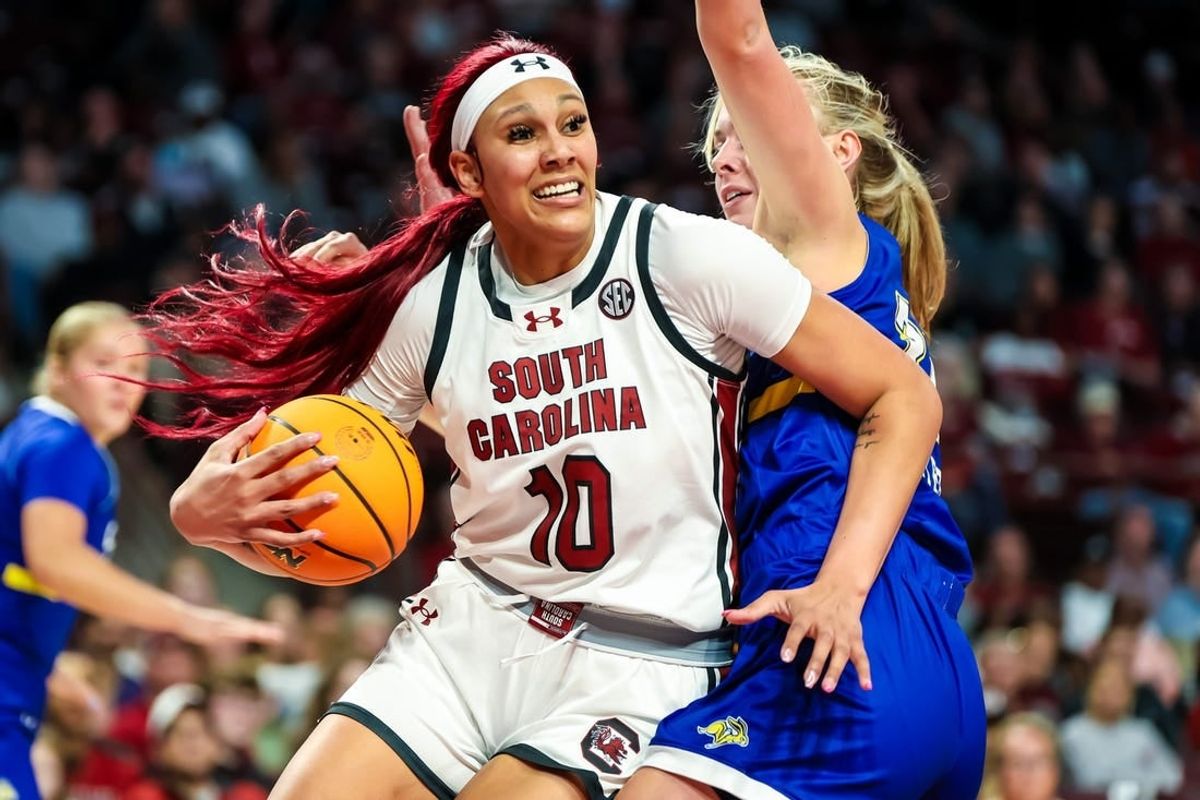 Nov 20, 2023; Columbia, South Carolina, USA; South Carolina Gamecocks center Kamilla Cardoso (10) drives around South Dakota State Jackrabbits forward Brooklyn Meyer (31) in the first half at Colonial Life Arena.