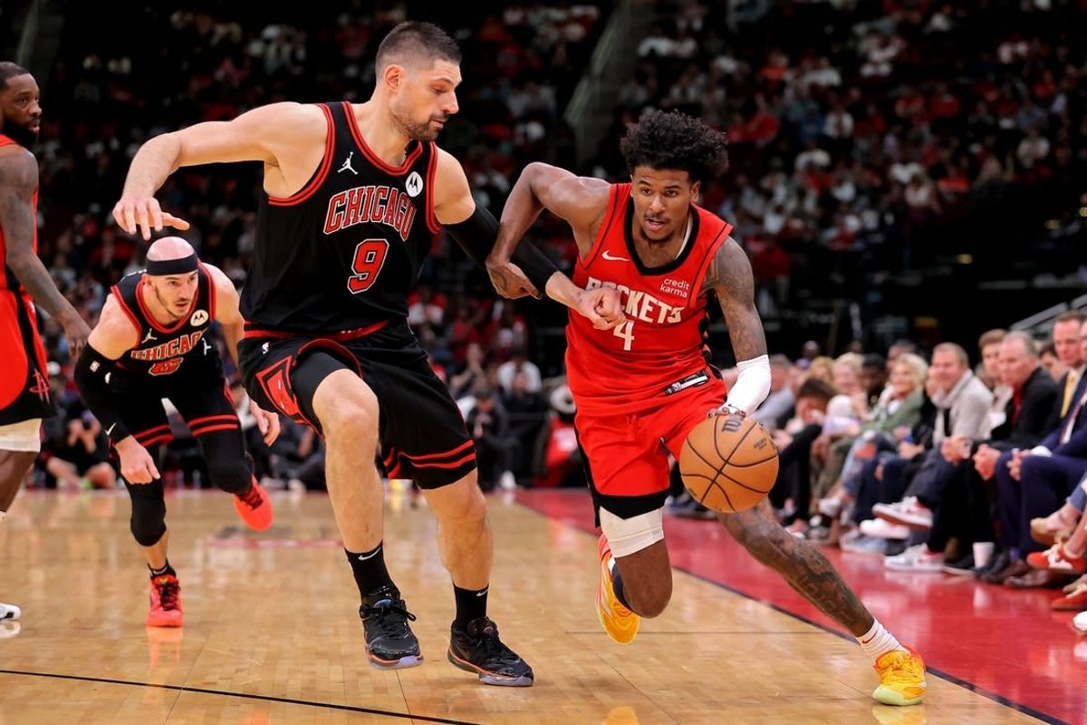 Mar 21, 2024; Houston, Texas, USA; Houston Rockets guard Jalen Green (4) handles the ball against Chicago Bulls center Nikola Vucevic (9) during the fourth quarter at Toyota Center.