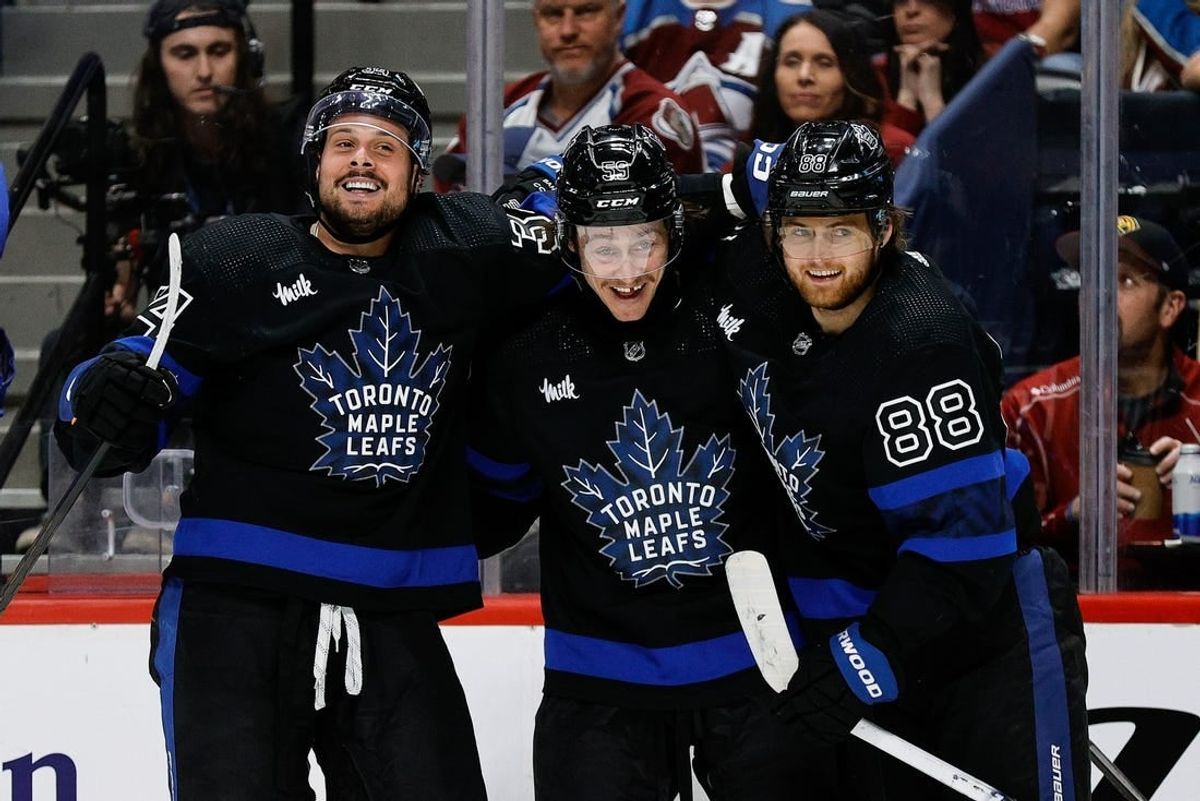 Feb 24, 2024; Denver, Colorado, USA; Toronto Maple Leafs left wing Tyler Bertuzzi (59) celebrates his hat trick goal with center Auston Matthews (34) and right wing William Nylander (88) in the third period against the Colorado Avalanche at Ball Arena.