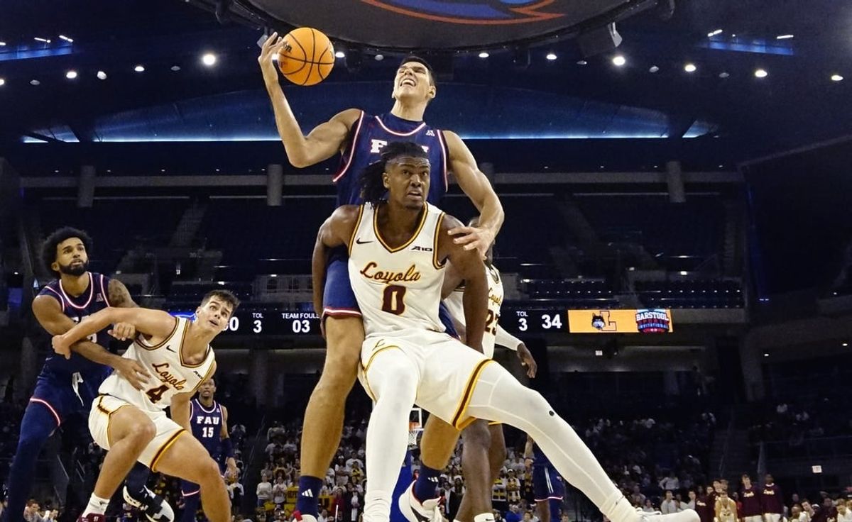 Nov 8, 2023; Chicago, Illinois, USA; Florida Atlantic Owls center Vladislav Goldin (50) is defended by Loyola Ramblers guard Desmond Watson (0)during the second half at Wintrust Arena.