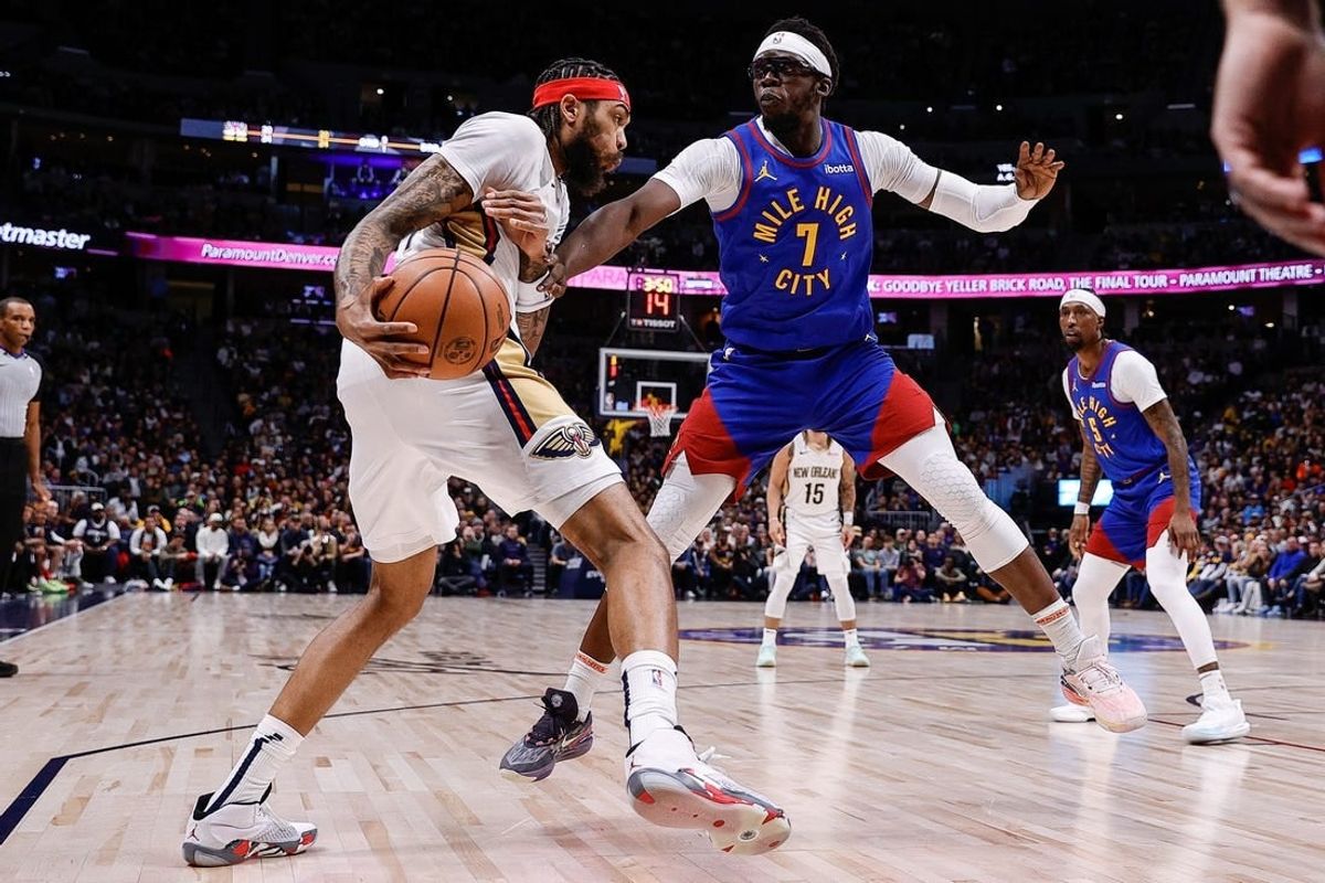 Jan 12, 2024; Denver, Colorado, USA; New Orleans Pelicans forward Brandon Ingram (14) controls the ball under pressure from Denver Nuggets guard Reggie Jackson (7) in the first quarter at Ball Arena.