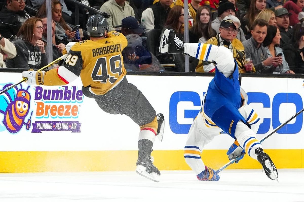 Dec 15, 2023; Las Vegas, Nevada, USA; Vegas Golden Knights center Ivan Barbashev (49) checks Buffalo Sabres center Dylan Cozens (24) during the second period at T-Mobile Arena.