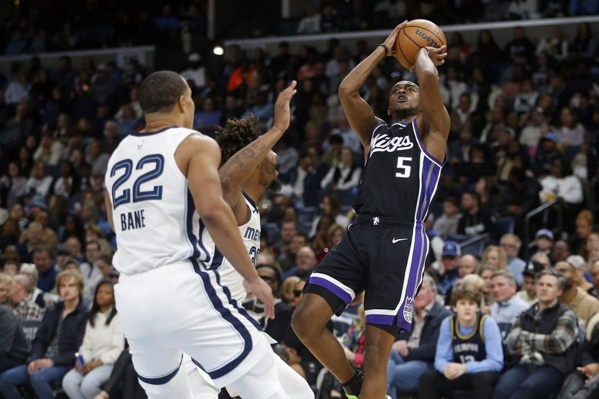 Dec 31, 2023; Memphis, Tennessee, USA; Sacramento Kings guard De'Aaron Fox (5) shoots as Memphis Grizzlies guard Marcus Smart (36) defends during the first half at FedExForum.