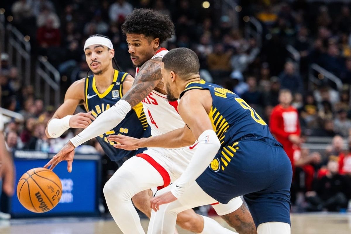 Feb 6, 2024; Indianapolis, Indiana, USA;  Houston Rockets forward Amen Thompson (1) dribbles the ball while Indiana Pacers guard Tyrese Haliburton (0) defends in the first half at Gainbridge Fieldhouse.