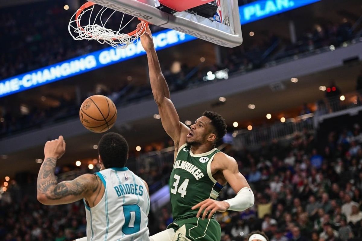 Feb 27, 2024; Milwaukee, Wisconsin, USA; Milwaukee Bucks forward Giannis Antetokounmpo (34) dunks the ball against Charlotte Hornets forward Miles Bridges (0) in the third quarter at Fiserv Forum.