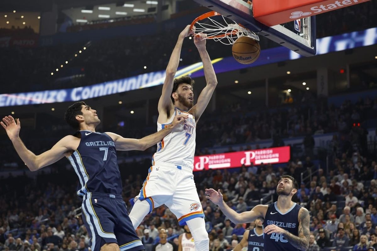 Dec 18, 2023; Oklahoma City, Oklahoma, USA; Oklahoma City Thunder forward Chet Holmgren (7) dunks against Memphis Grizzlies forward Santi Aldama (7) during the second quarter at Paycom Center.