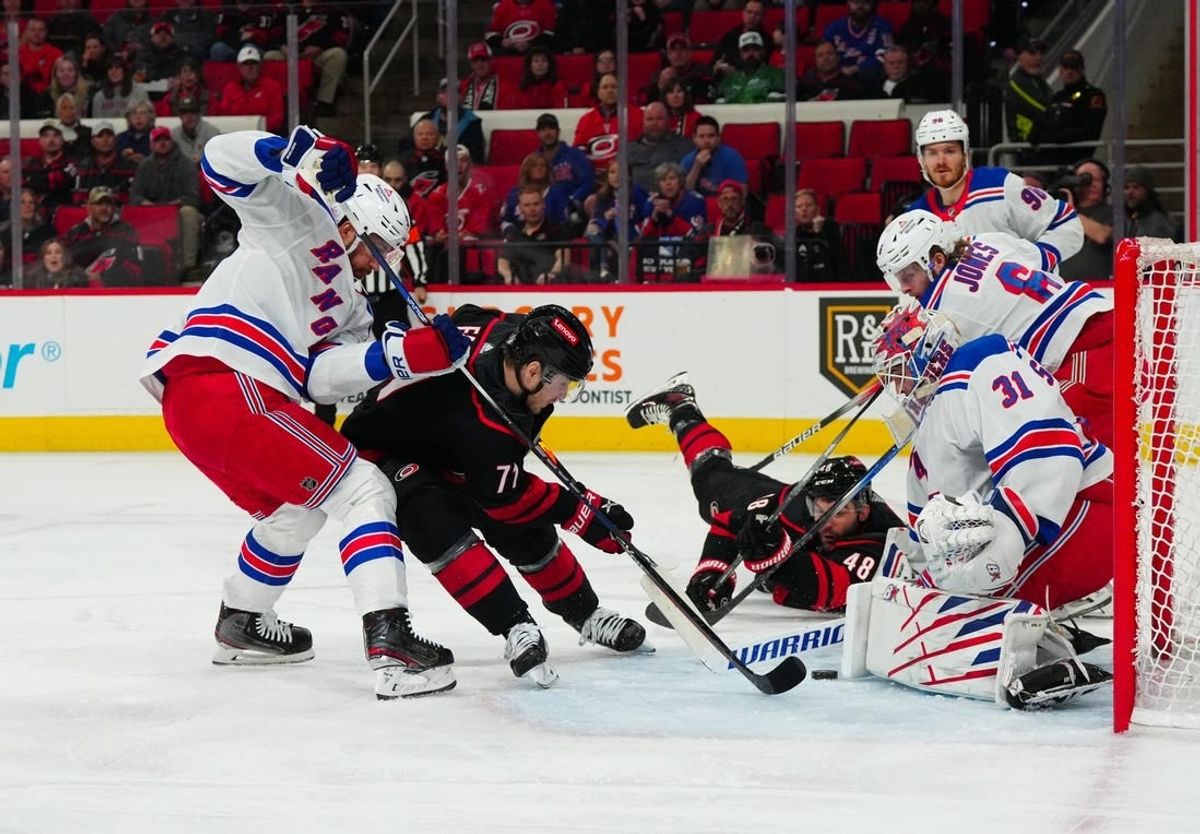Mar 12, 2024; Raleigh, North Carolina, USA; Carolina Hurricanes right wing Jesper Fast (71) shot attempt is stopped by New York Rangers defenseman Erik Gustafsson (56) and goaltender Igor Shesterkin (31) during the first period at PNC Arena.