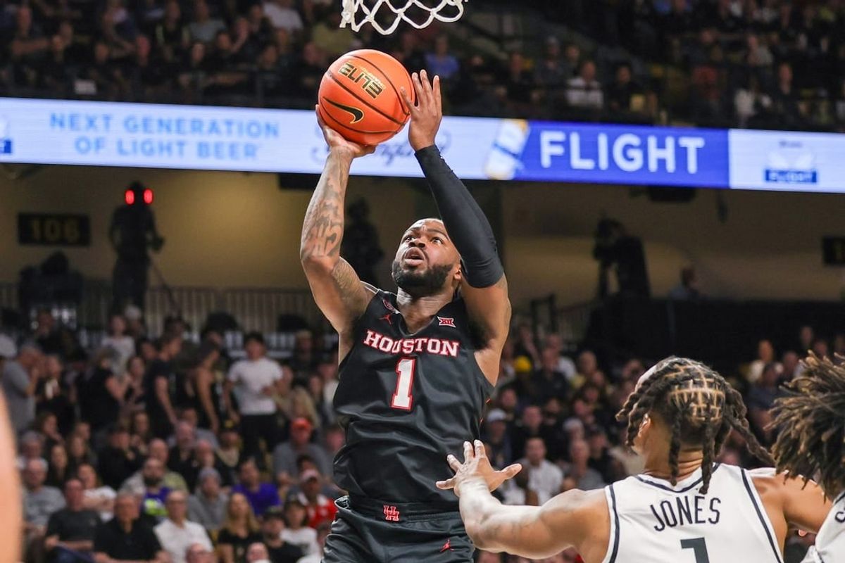 Mar 6, 2024; Orlando, Florida, USA; Houston Cougars guard Jamal Shead (1) goes to the basket in front of UCF Knights guard Antwann Jones (1) during the first half at Addition Financial Arena.