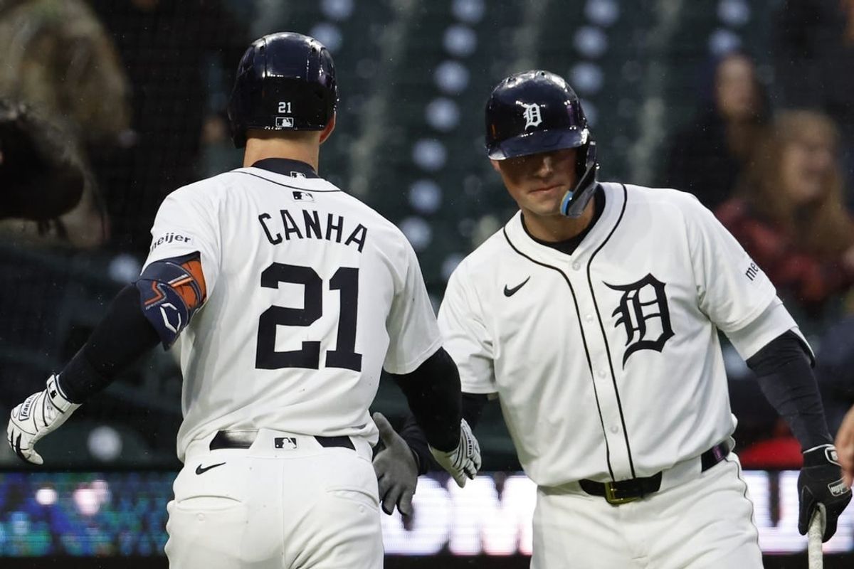 Apr 12, 2024; Detroit, Michigan, USA;  Detroit Tigers designated hitter Mark Canha (21) receives congratulations from Detroit Tigers first baseman Spencer Torkelson (20) after he hits a home run in the first inning against the Minnesota Twins hits a home runat Comerica Park.
