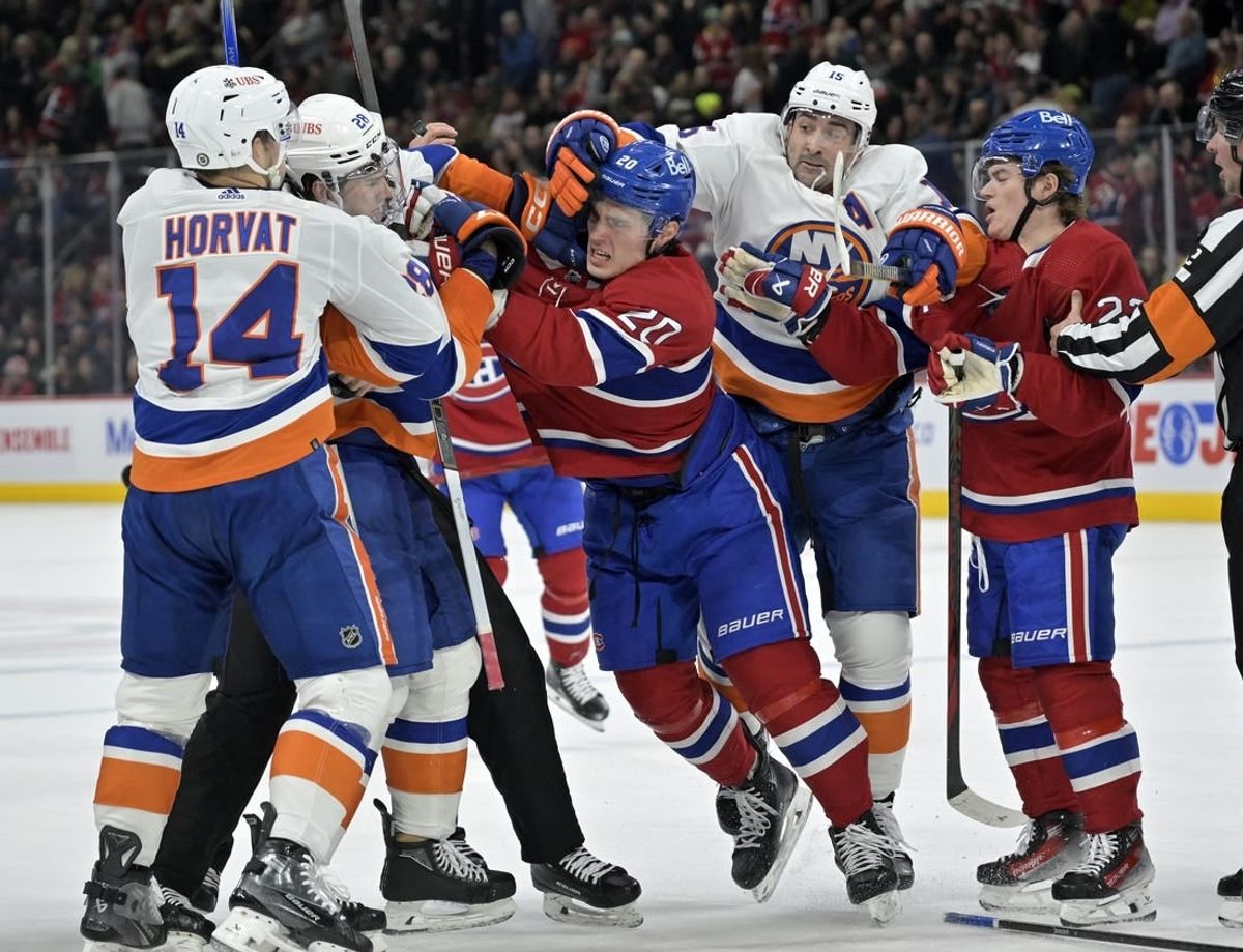 Jan 25, 2024; Montreal, Quebec, CAN; Montreal Canadiens forward Juraj Slafkovsky (20) exchanges blows with New York Islanders defenseman Alexander Romanov (28) during the first period at the Bell Centre.