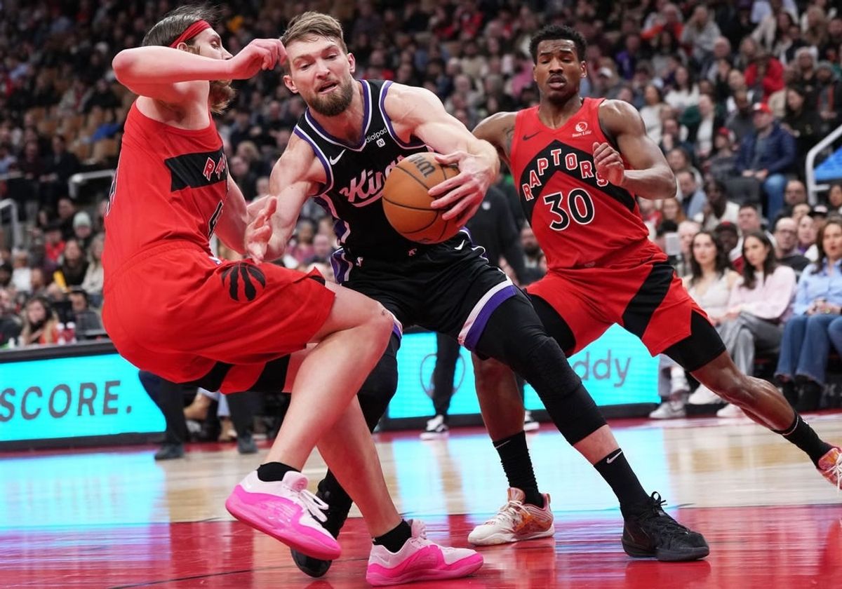 Mar 20, 2024; Toronto, Ontario, CAN; Sacramento Kings forward Domantas Sabonis (10) controls the ball as Toronto Raptors forward Kelly Olynyk (41) tries to defend during the second quarter at Scotiabank Arena.