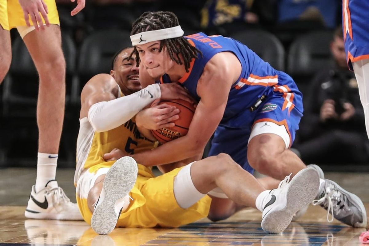 Nov 22, 2023; Brooklyn, New York, USA; Pittsburgh Panthers guard Ishmael Leggett (5) and Florida Gators guard Walter Clayton Jr. (1) battle for a loose ball in the second half at Barclays Center.