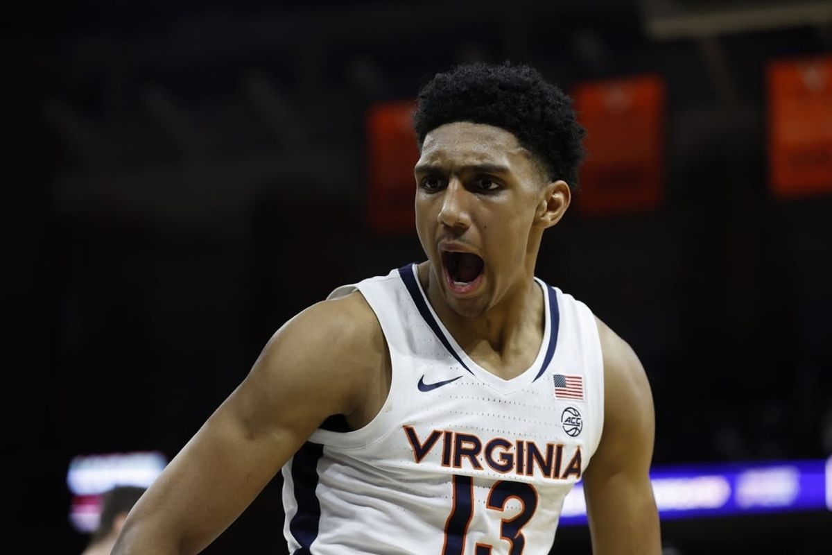 Jan 24, 2024; Charlottesville, Virginia, USA; Virginia Cavaliers guard Ryan Dunn (13) reacts after a dunk against the North Carolina State Wolfpack in overtime at John Paul Jones Arena.