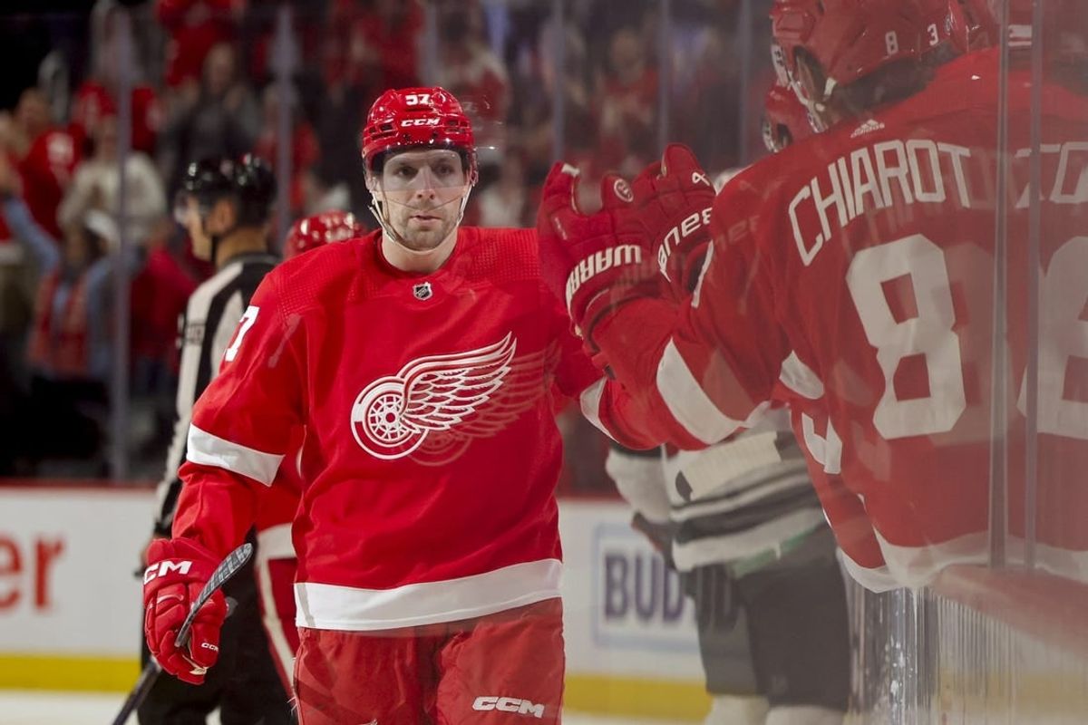 Nov 26, 2023; Detroit, Michigan, USA; Detroit Red Wings left wing David Perron (57) receives congratulations from teammates after scoring in the third period against the Minnesota Wild at Little Caesars Arena.