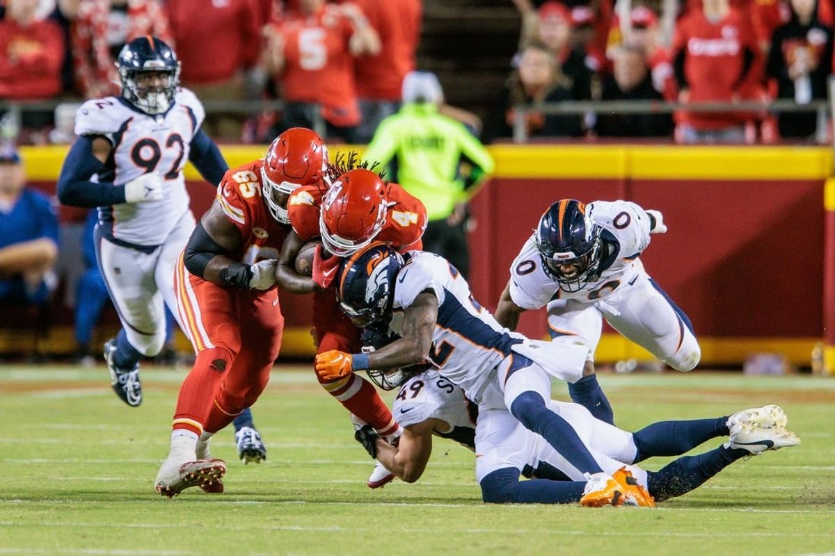 Oct 12, 2023; Kansas City, Missouri, USA; Kansas City Chiefs wide receiver Rashee Rice (4) is hit by Denver Broncos safety Kareem Jackson (22) during the fourth quarter at GEHA Field at Arrowhead Stadium.