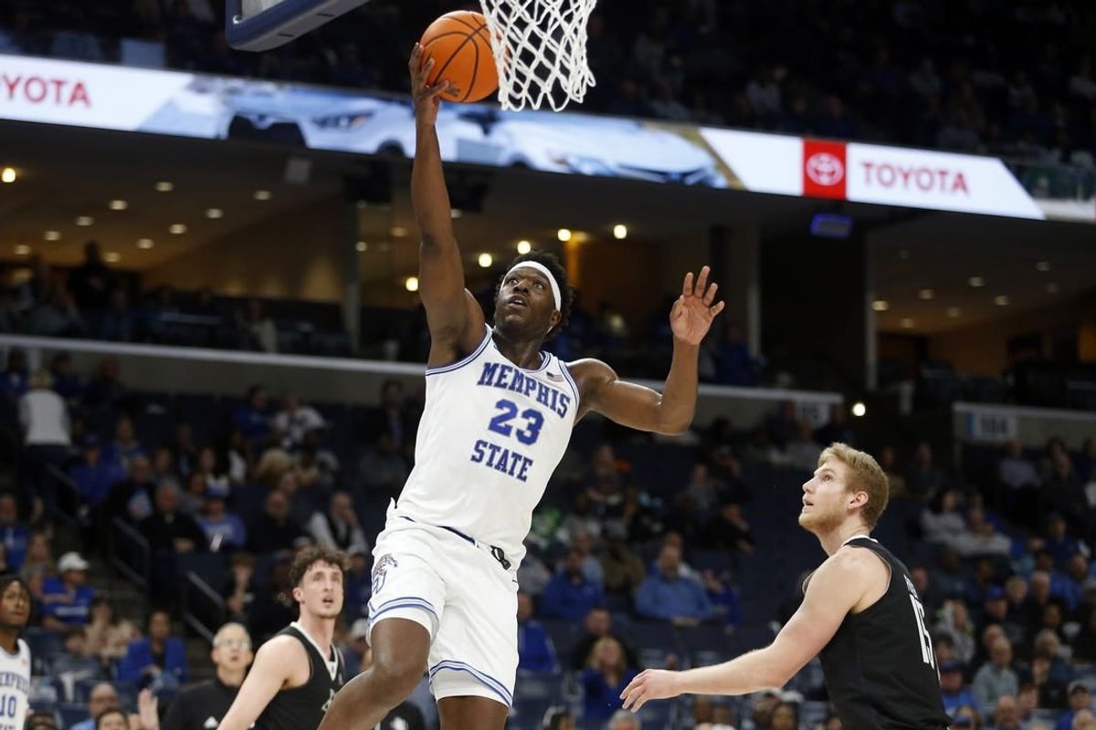 Jan 31, 2024; Memphis, Tennessee, USA; Memphis Tigers forward Malcolm Dandridge (23) drives to the basket as Rice Owls forward Max Fiedler (15) defends during the first half at FedExForum.