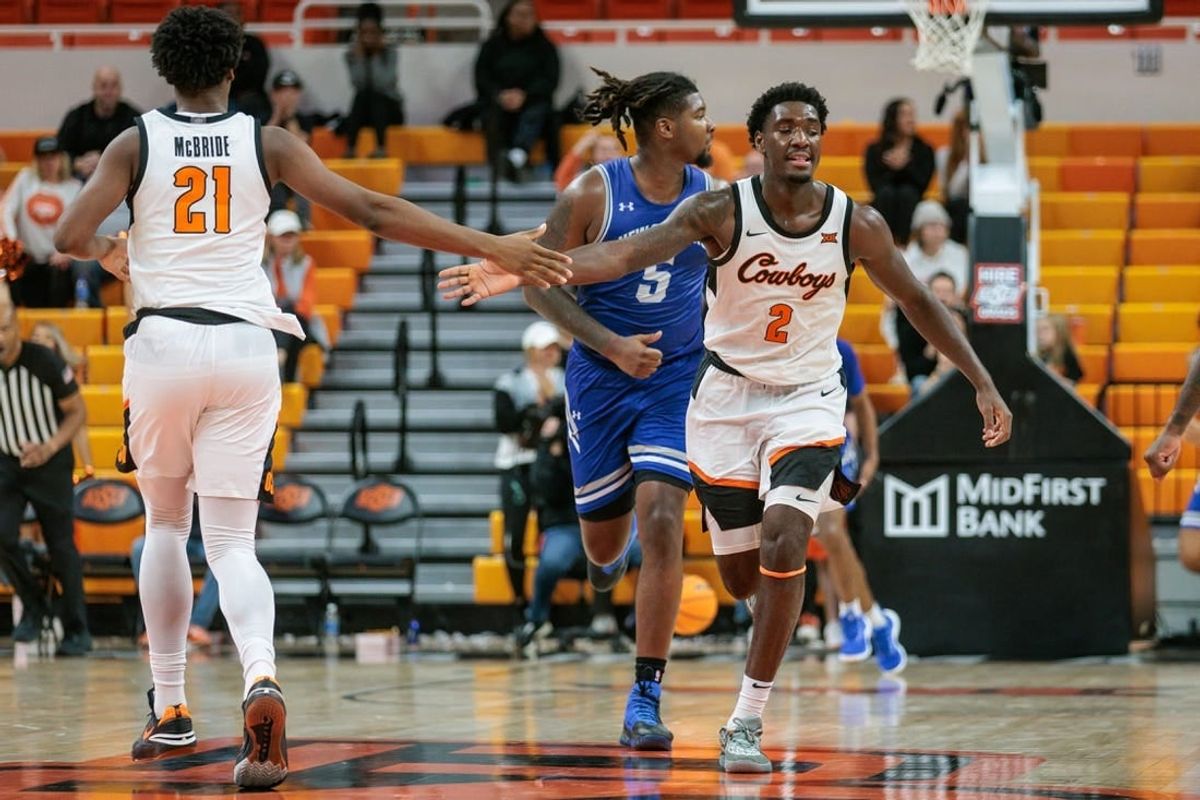 Nov 20, 2023; Stillwater, Oklahoma, USA; Oklahoma State Cowboys forward Justin McBride (21) and forward Eric Dailey Jr. (2) slap hands after a play during the second half against the New Orleans Privateers at Gallagher-Iba Arena.