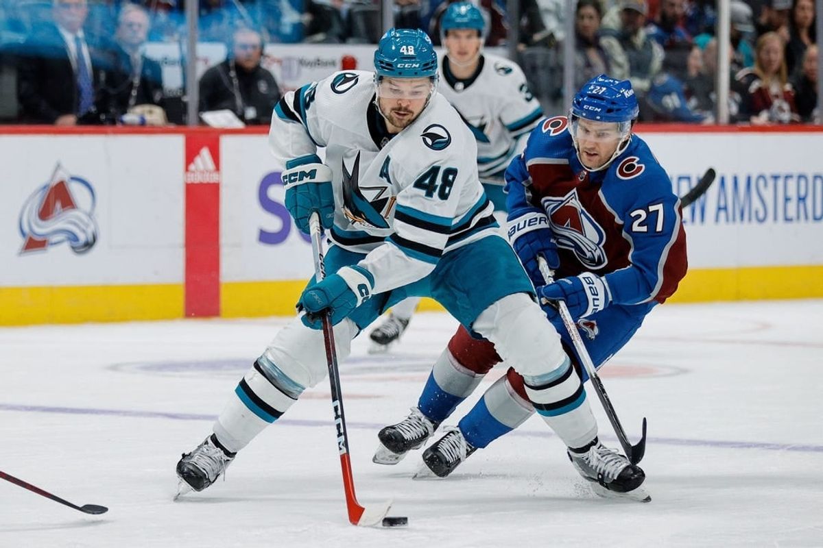 Dec 17, 2023; Denver, Colorado, USA; San Jose Sharks center Tomas Hertl (48) controls the puck ahead of Colorado Avalanche left wing Jonathan Drouin (27) in the third period at Ball Arena.