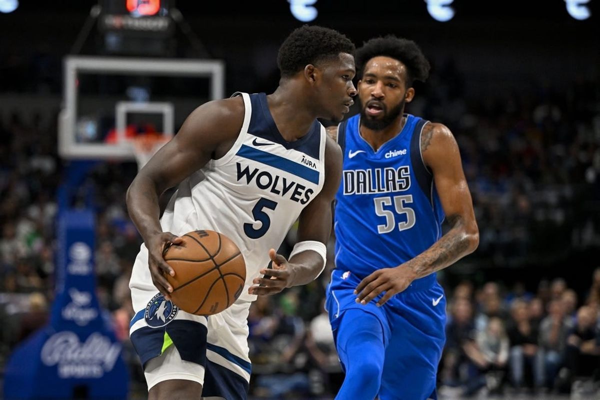 Dec 14, 2023; Dallas, Texas, USA; Minnesota Timberwolves guard Anthony Edwards (5) \looks to move the ball past Dallas Mavericks forward Derrick Jones Jr. (55) during the first quarter at the American Airlines Center.