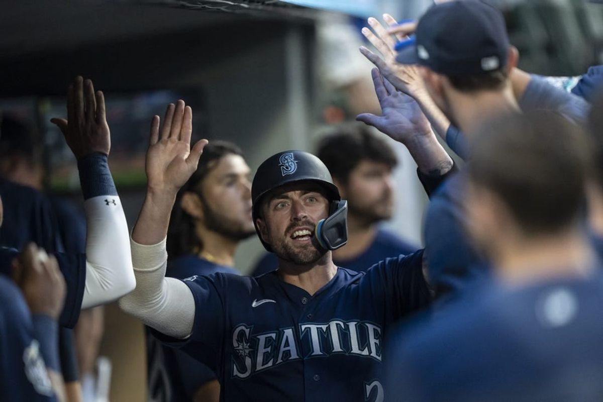 Aug 8, 2023; Seattle, Washington, USA; Seattle Mariners catcher Tom Murphy (2) celebrates in the dugout after scoring a run during the sixth inning against the San Diego Padres at T-Mobile Park.