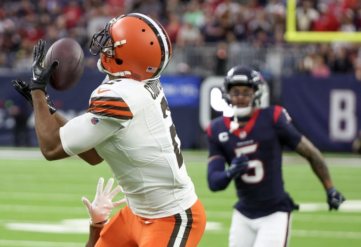 Dec 24, 2023; Houston, Texas, USA; Cleveland Browns wide receiver Amari Cooper (2) catches a touchdown pass with Houston Texans safety Jalen Pitre (5) chasing in the second quarter at NRG Stadium.
