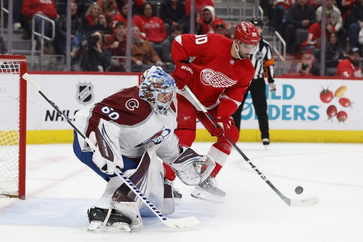 Feb 22, 2024; Detroit, Michigan, USA;  Detroit Red Wings center Joe Veleno (90) tries to score on Colorado Avalanche goaltender Justus Annunen (60) in the second period at Little Caesars Arena.