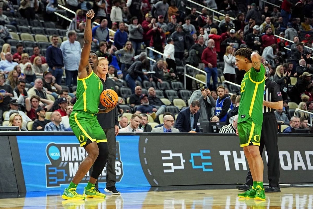 Mar 21, 2024; Pittsburgh, PA, USA; Oregon Ducks center N'Faly Dante (1) and guard Jadrian Tracey (22) celebrate with head coach Dana Altman after beating the South Carolina Gamecocks in the first round of the 2024 NCAA Tournament at PPG Paints Arena.